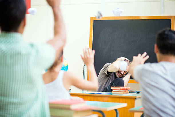 istock School education scene: students throwing papers at teacher 531346965