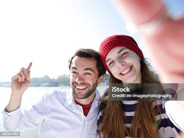 Young Man And Woman Taking Selfie On Mobile Phone Stock Photo - Download Image Now - 20-29 Years, 2015, Adult