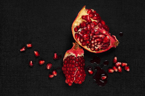 Luxurious pomegranate background. Luxurious pomegranate background. Pomegranate core on black background, top view. Healthy fruit eating. healthy eating red above studio shot stock pictures, royalty-free photos & images