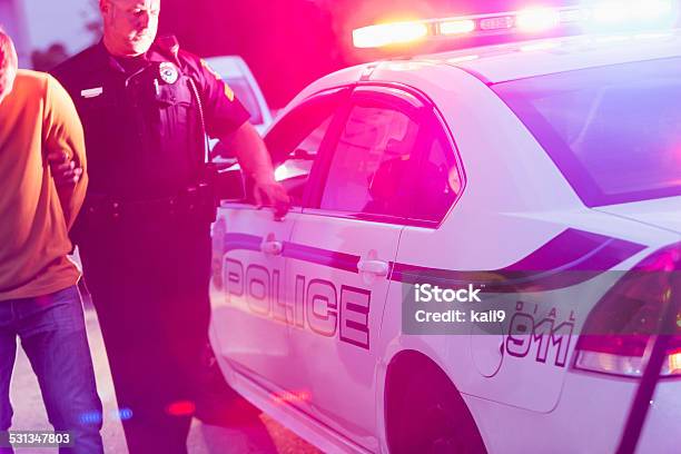 Police Officer Arresting A Young Man At Night Stock Photo - Download Image Now - Arrest, Police Force, Drunk Driving