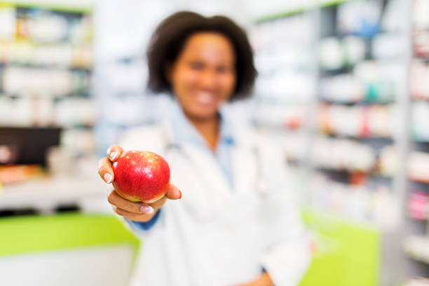 istock African American pharmacist holding apple. 531348065
