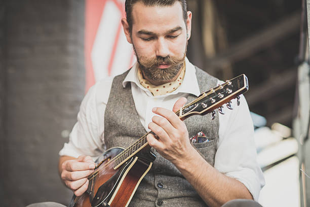 istock handsome big moustache hipster man playing mandolin 531348989
