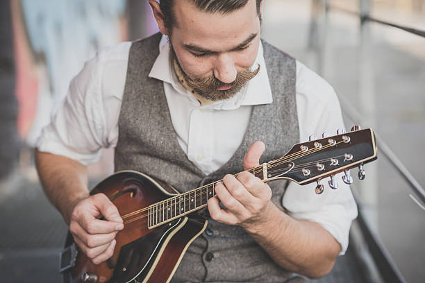 istock handsome big moustache hipster man playing mandolin 531348993