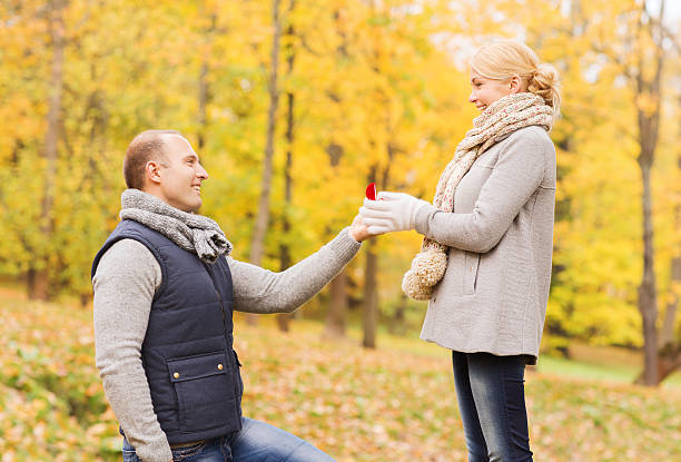 istock smiling couple with engagement ring in gift box 531349593