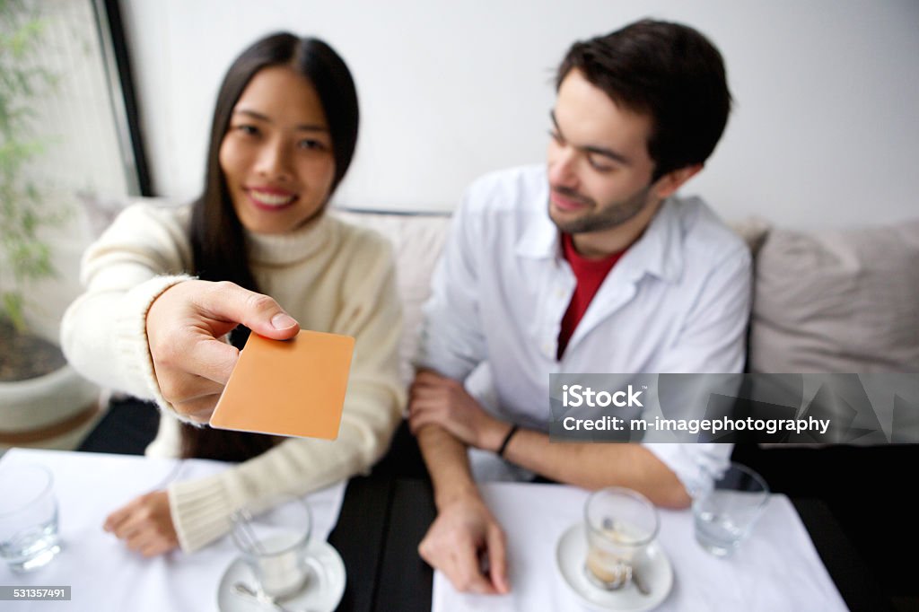 Happy couple paying for meal with card at restaurant Portrait of a happy couple paying for meal with card at restaurant Dinner Stock Photo