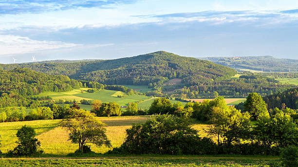 Spring Countryside Northern Bavarian Spring Hill Landscape. Warm Colors. Trees and Hills. Forest of Franconia. Well-Known for Hiking. Beautiful Picturesque Nature franconia stock pictures, royalty-free photos & images
