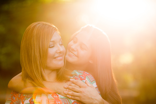 Happy mother and daughter enjoying in a park