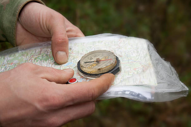 compass and map in hand. closeup. stock photo