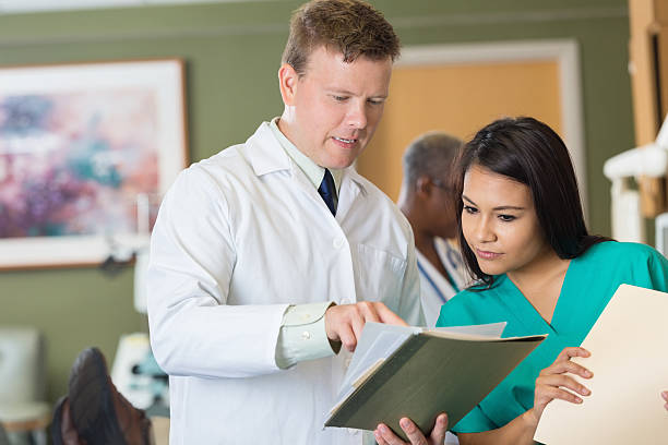 istock Doctor explaining patient chart to nurse in hopsital blood lab 531360265