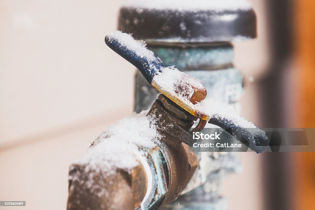 Frozen water shut off handle in snowstorm Frozen Stock Photo