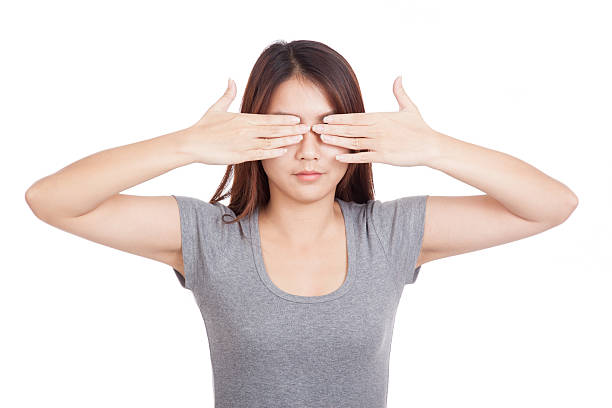 istock Young Asian woman close  eyes with both hands 531362747