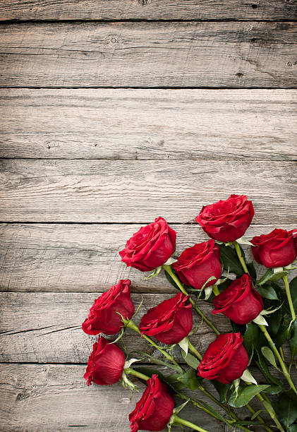 istock Valentine's day red roses bouquet on old rustic wood table 531363053