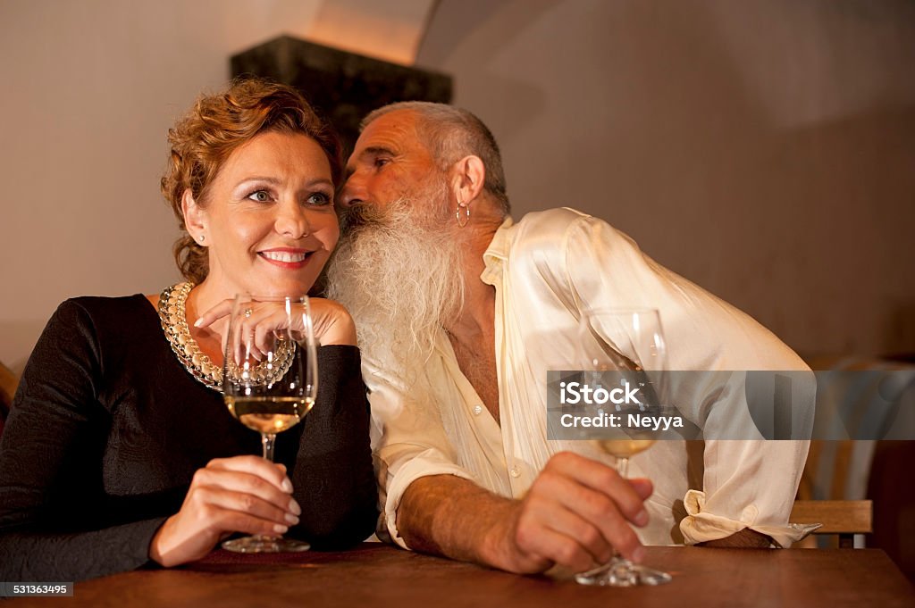 Mature Couple in Winery Cellar Attractive mature couple drinking wine in winery cellar. Goriška Brda, Slovenia. 2015 Stock Photo