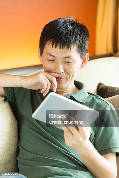 Asian Young Male Adult Looking Tablet Stock Photo - Download Image Now - Close To, Device Screen, Human Face