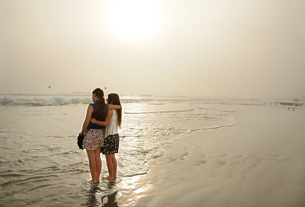 istock Sisters enjoying time together on beautiful beach. 531372823