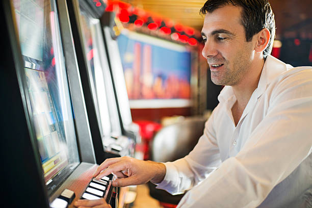 istock Man gambling on slot machines. 531372859