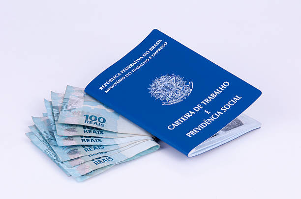 istock Brazilian work document (carteira de trabalho) and brazilian currency 531384995