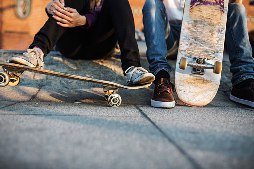 Close-up shot of skater's feet resting on skateboard