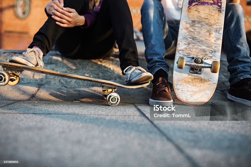 Young Skater Relaxing Close-up shot of skater's feet resting on skateboard Skateboarding Stock Photo