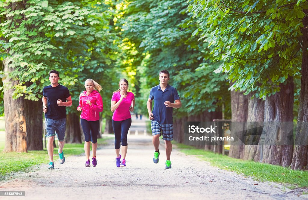 Friends jogging Young friends jogging in the park 2015 Stock Photo