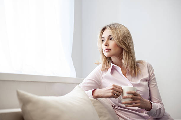 istock Attractive young lady is enjoying hot drink 531394862