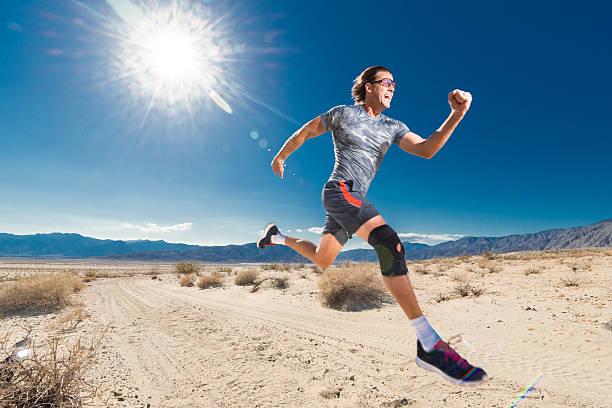 Man With Knee Brace Running In The Desert Man With Knee Brace Running In The Desert knee brace stock pictures, royalty-free photos & images