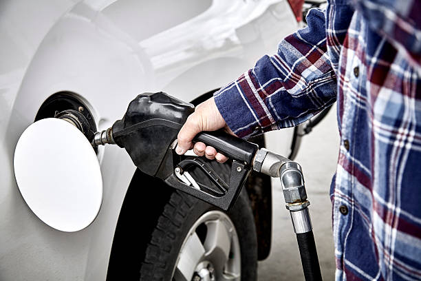 istock Mans Hand holding Gas Nozzle to Refuel Vehicle 531396782