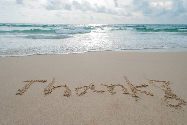istock The Word thank Written on Sand 531397667