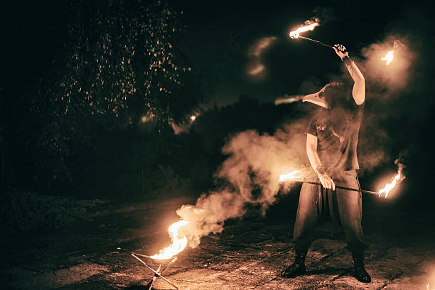 istock active European guy carries out tricks for fire show night 531399281