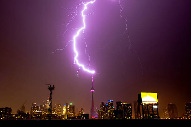 Toronto Tower Struck by Lightning The CN Tower being struck by lightning. lightning tower stock pictures, royalty-free photos & images