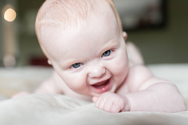 istock Beautiful Baby Having Fun on Bed 531399400