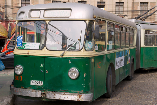 Valparaiso, Chile - October 19, 2013: Unidentified man enters old trolleybus on October 19, 2013 in Valparaiso, Chile. Old trolleybus system from 1950's  is one of the icons of Valparaiso city.