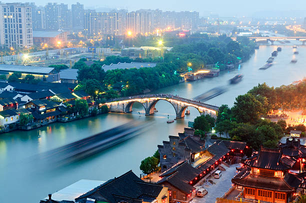 Hangzhou canal gongchen bridge at dusk Hangzhou， China-  July 11，2014: gongchen bridge at dusk the beauty of the scene, in June this year, China's grand canal to apply for world cultural heritage succeed grand canal china stock pictures, royalty-free photos & images