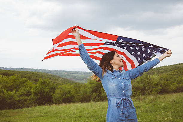 istock Attractive  beauty waving an U.S.A. flag with wide open arms 531400722
