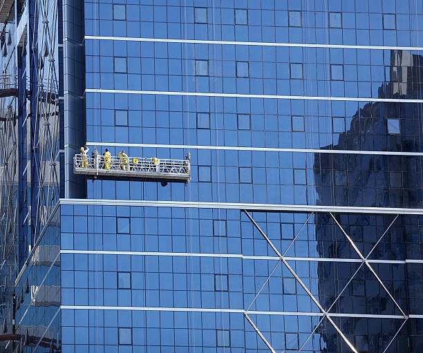 Window washer Window cleaner and maintenance on the outside of a skyscraper steeplejack stock pictures, royalty-free photos & images