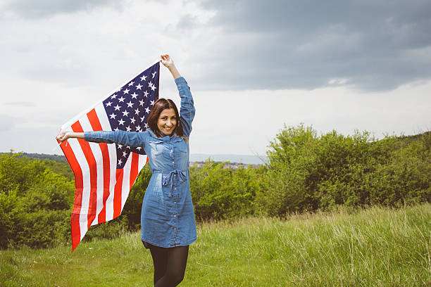 istock Cheering girl waving the American flag 531401012