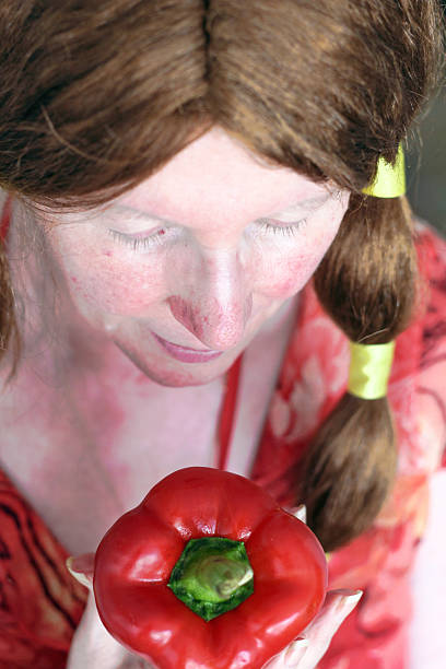 istock Earthy Feminine, soft woman looking down holding pepper 531401701