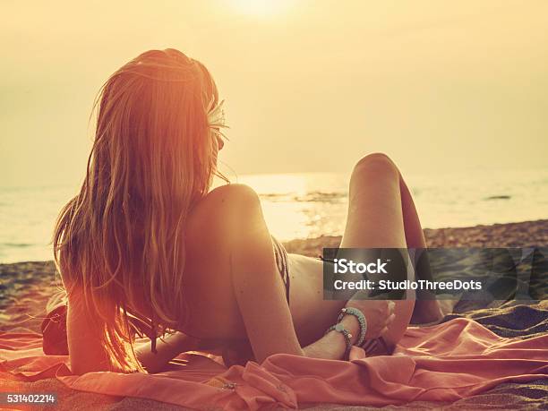 Woman Relaxing On Beach Stock Photo - Download Image Now - Beach, Sunbathing, Women