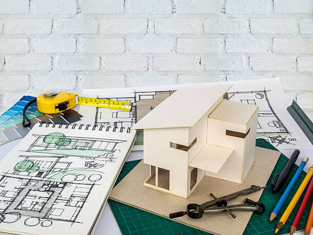 istock Architects workspace with house model & blueprints/ Home renovation concept 531404286