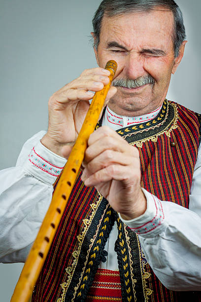 istock Pipe player in traditional clothing 531404373