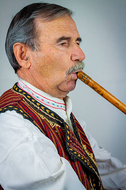 istock Pipe player in traditional clothing 531404379