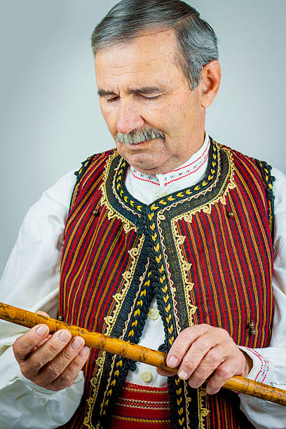 istock Pipe player in traditional clothing 531404385
