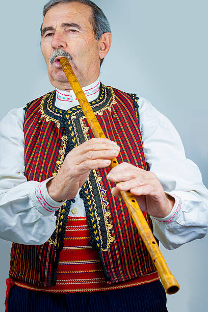 istock Pipe player in traditional clothing 531404387