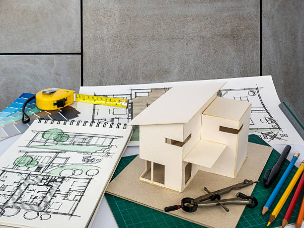 istock Architects workspace with house model & blueprints/ Home renovation concept 531404416