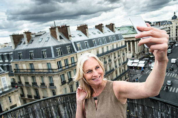 istock french woman take a selfie on the rooftop in paris 531404782