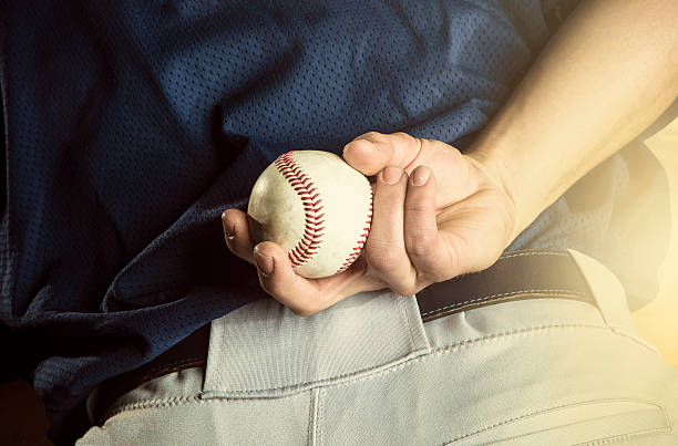 Baseball pitcher ready to pitch. Close up of hand A close up view of the baseball pitchers hand just before throwing a fastball in a game. Focus on the fingers and the ball baseball uniform stock pictures, royalty-free photos & images