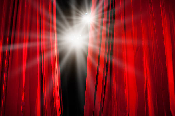 Red Curtain Opening with Stage Lights Shining Through Red Curtain Opening with Stage Lights Shining Through stage light stock pictures, royalty-free photos & images