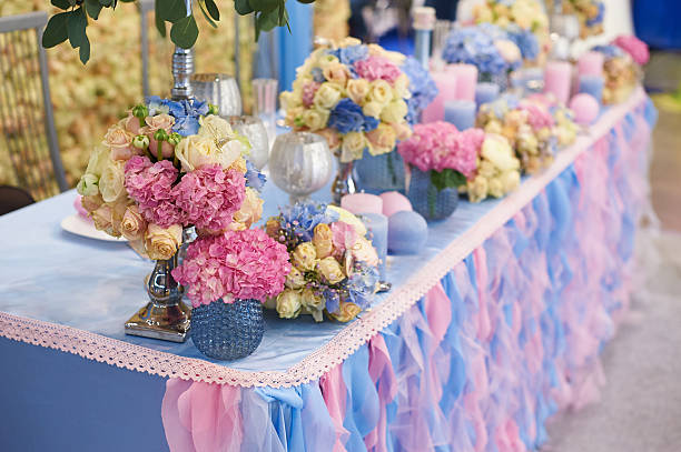 istock Table set for wedding reception with candles and flower bouquets 531409296