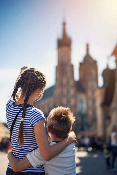 istock Kids visiting Krakow and looking at Mariacki Church (St. Mary) 531410132
