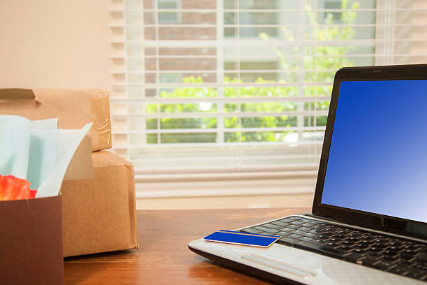 istock Online shopping using credit card, laptop at home.  Packages. 531412506